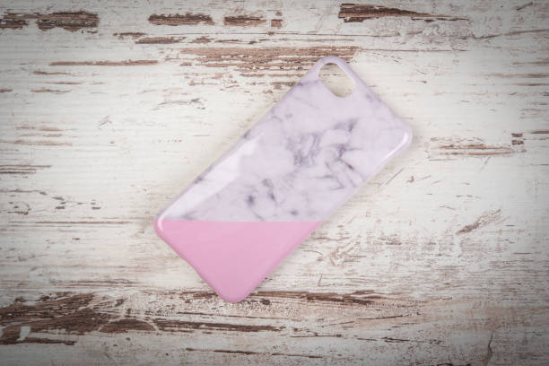 Mobile phone cover on white rustic wooden background
