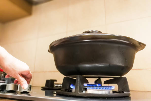 istock Ceramic clay pot on gas fire generated stove 884695370