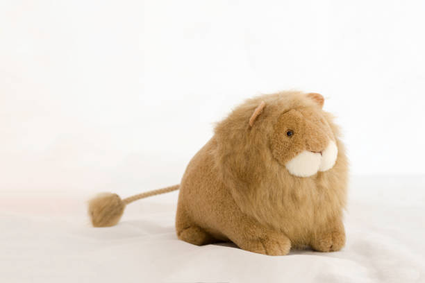 stuffed animal lion on a white background .