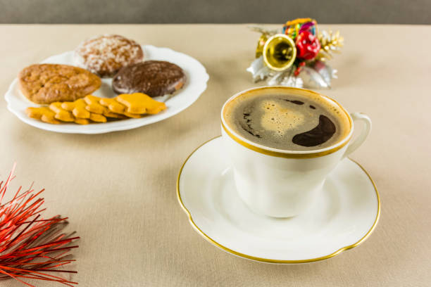istock Coffee served in a white cup for Christmas and gingerbread in the background. 884698006