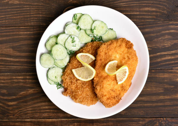 istock Tasty schnitzel with cucumber salad 884698720