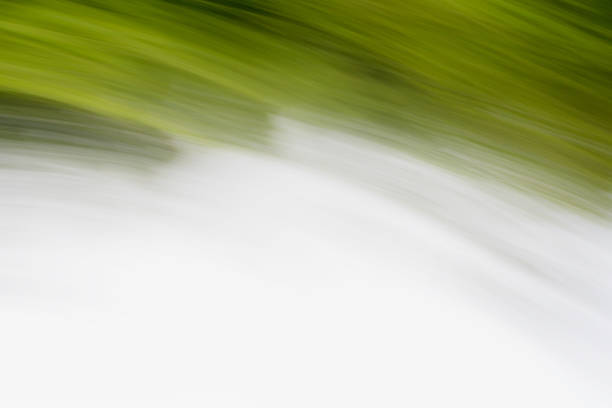 istock Abstract background from fast movement of grass and water 884702326