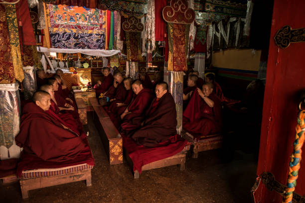Thiksey, India - September 4, 2011: Tibetan Buddhist monks during prayer in Thiksey gompa (Buddhist monastery) of the Yellow Hat (Gelugpa) sect - the largest gompa in central Ladakh