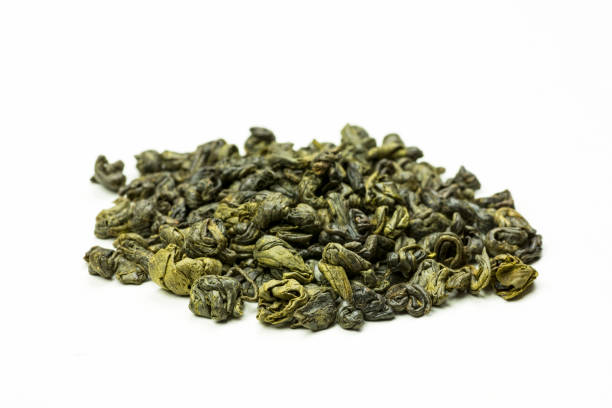 istock A stack of rolled green tea leaves on a white background 884707474