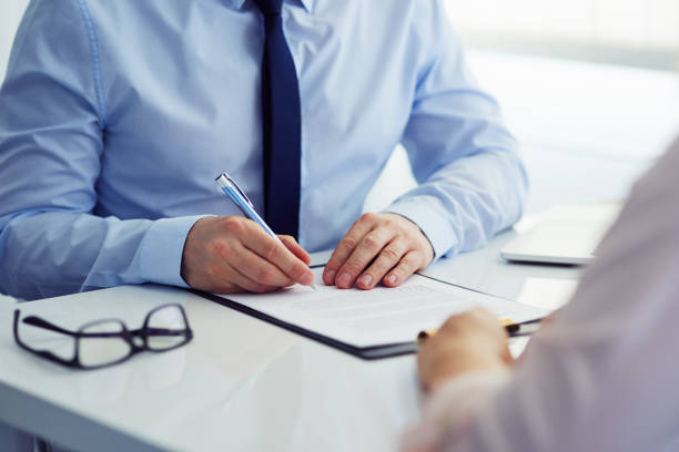 istock Man signing a contract in the office 884707846