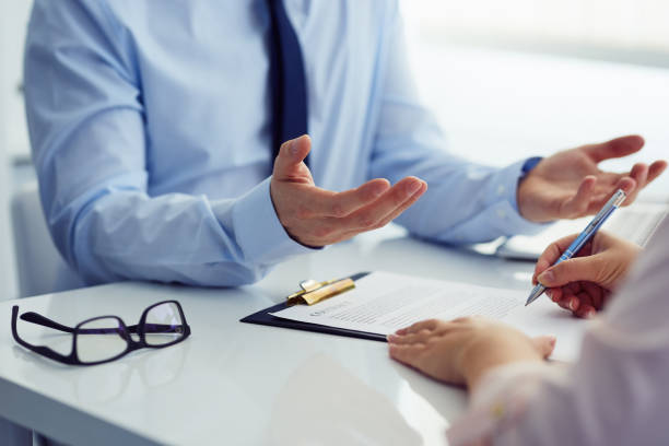 istock Businessman explaining the contract to the client 884707852