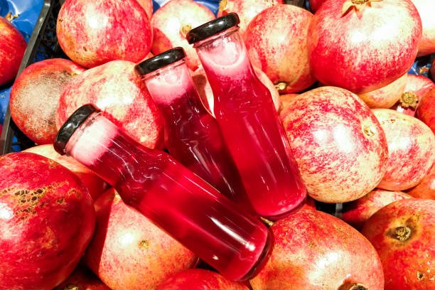 istock Fresh cold pressed organic pomegranate juice against pomegramate fruits 884708062
