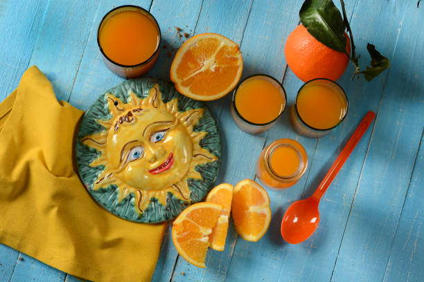 istock Sicilian orange juice on blue table 884710978