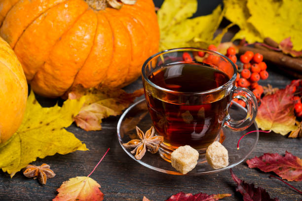 istock Cup of tea on the rustic background with autumn decoration 884722780