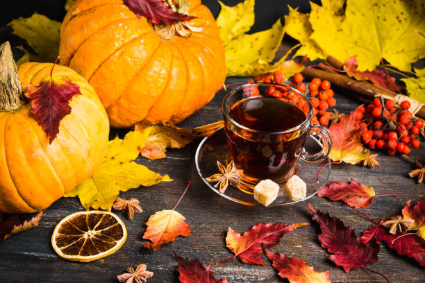 istock Cup of tea on the rustic background with autumn decoration 884722830