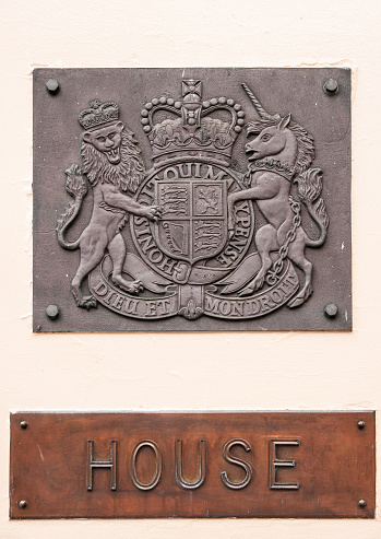 Adelaide SA, Australia - November 20, 2009: Two metal embossed signs at entrance to House of Parliament of South Australia Parliament show coat of arms with lion and unicorn.