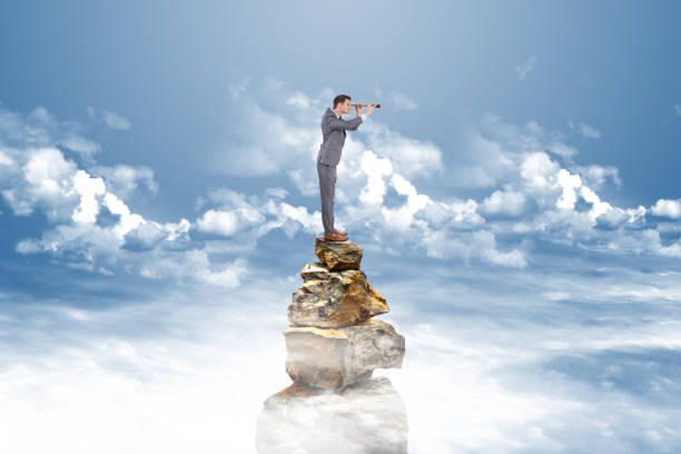 istock Businessman searching through telescope 884726970