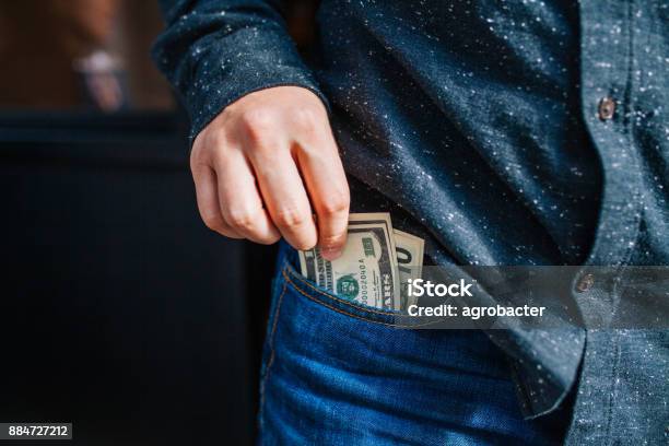 Human Hand Is Putting Money In The Pocket Stock Photo - Download Image Now - Pocket, Currency, Paper Currency