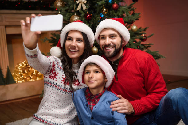 istock family taking selfie at christmas 884727744