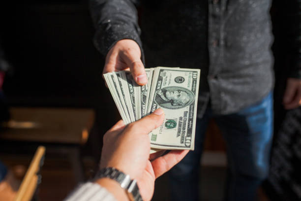 istock Man hands giving money 884729866
