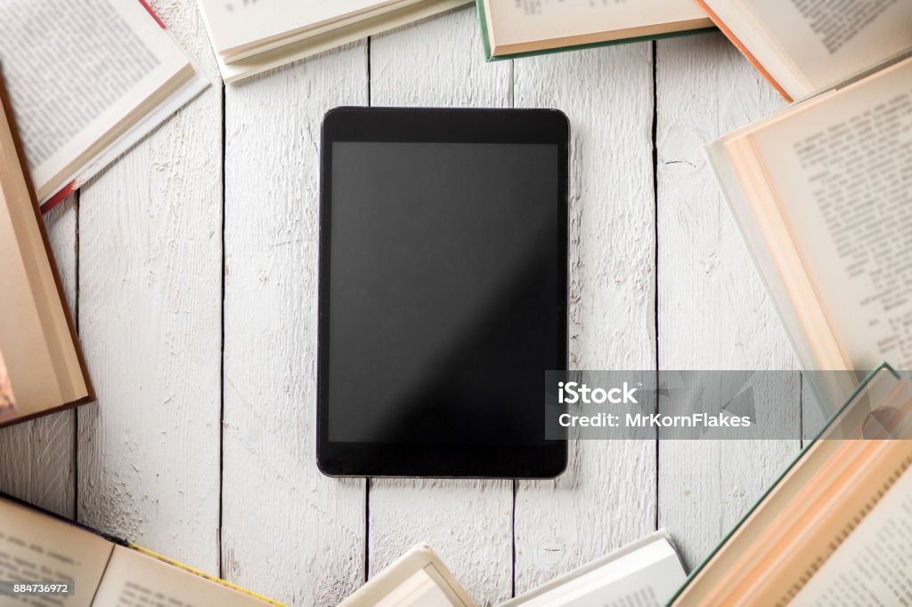 Ebook Reader with Books Black Ebook Reader with Many Paper Books Book Stock Photo