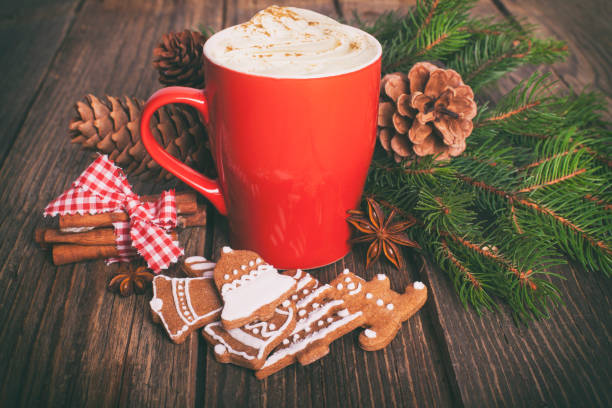 istock Christmas cappuccino and gingerbread cookies infront Christmas tree 884737204