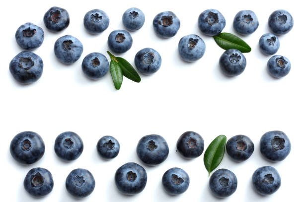 istock blueberries with green leaf isolated on white background. top view 884764470
