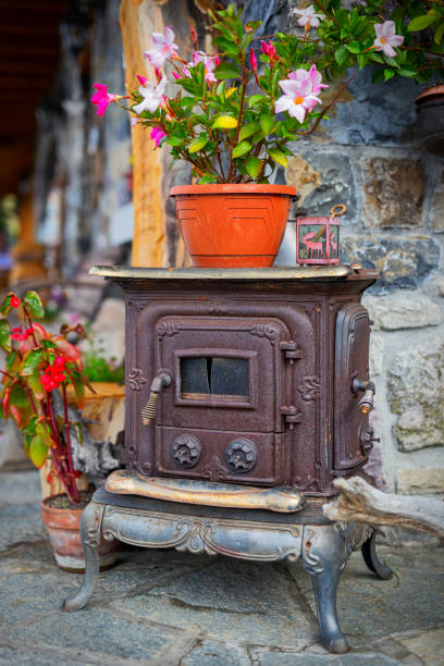 istock close up ancient cast iron stove with flowers above 884775938