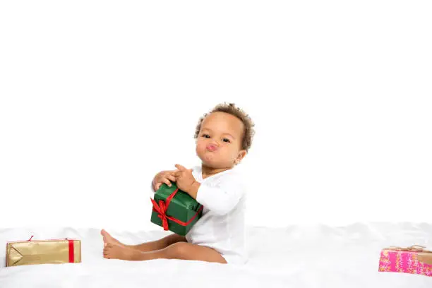 Photo of african american toddler with gifts