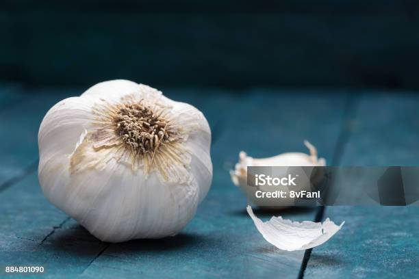 White Garlic On Petrolcolored Wooden Background Stock Photo - Download Image Now - Garlic, Germany, Backgrounds