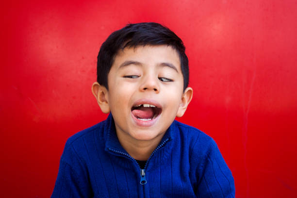 istock boy with tongue-faced outside 884801204