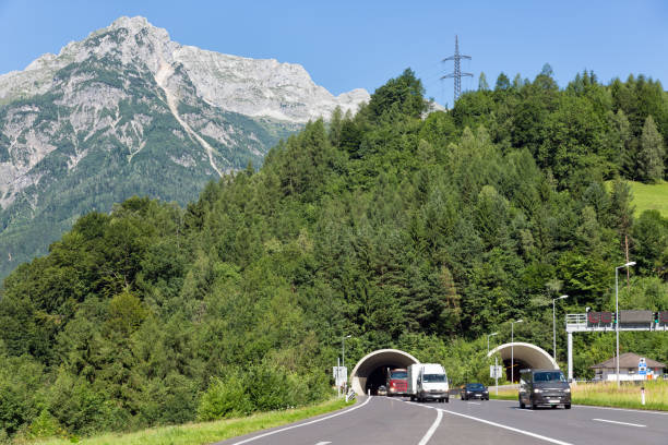 istock Austrian highway with cars leaving a tunnel through a mountain 884827202