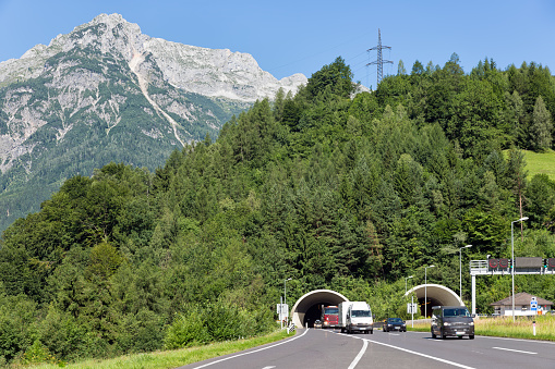 Austrian highway with cars leaving a tunnel through a mountain
