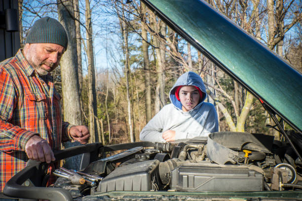 istock A father and son working on a SUV or truck 884827556