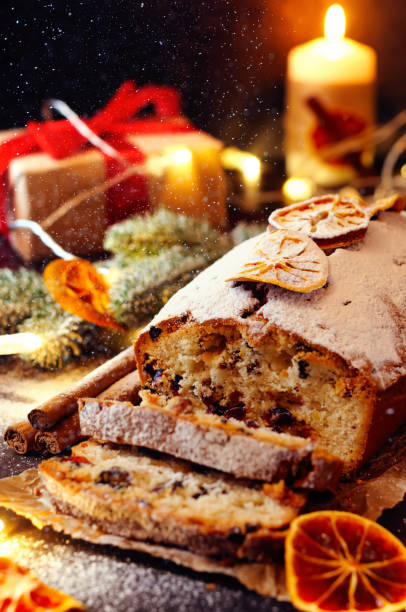 istock Christmas fruitcake with festive decirations. Falling snowflakes 884827690