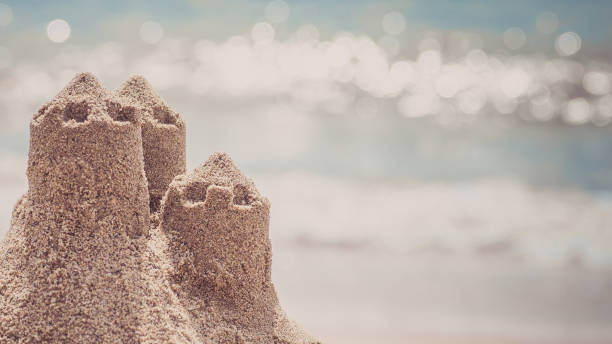 istock Sand castle standing on the beach. Travel vacations concept. 884833848