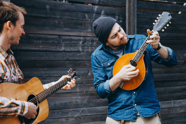 istock Hipster musicians are playing on the street. 884839014