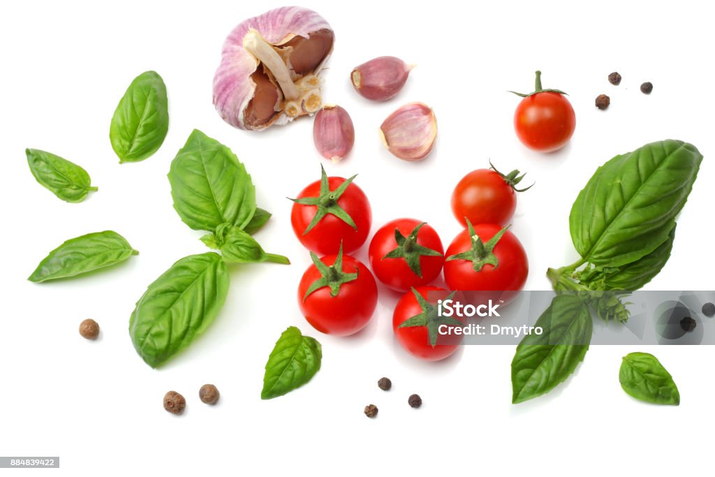 mix of slice of tomato, basil leaf, garlic and spices isolated on white background. top view Above Stock Photo