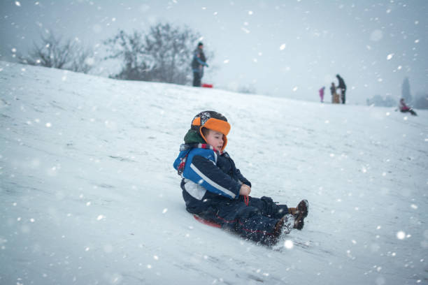 istock Little boy enjoying sleigh ride during snowfall. 884845314