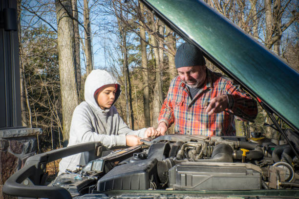istock A father and son working on a SUV or truck 884851998