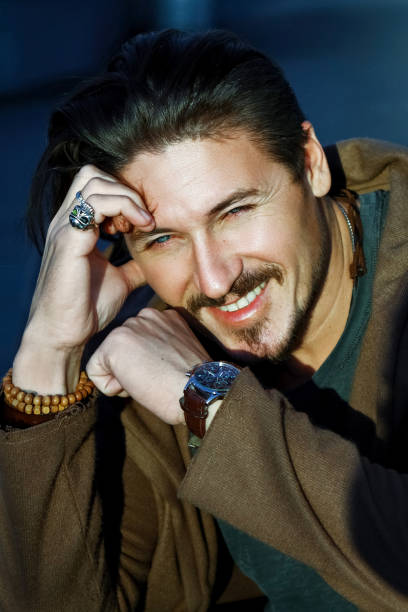 istock Handsome trendy guy with blue eyes smiling outdoors 884861106