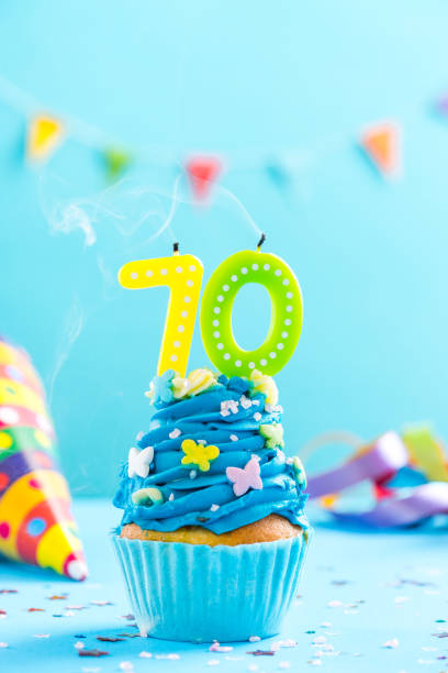 istock Seventieth 70th birthday cupcake with candle blow out.Card mockup. 884874036