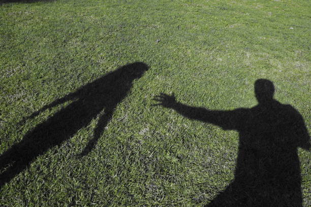 shadow A man's shadow touches the shadow of a girl kidnapping photos stock pictures, royalty-free photos & images