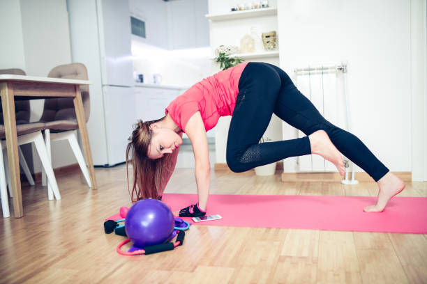 istock Young Female Exercise Yoga Pilates at Home 884879974