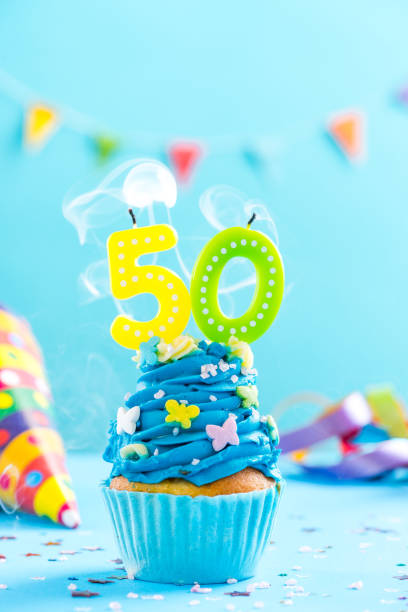 istock Fiftieth 50th birthday cupcake with candle blow out.Card mockup. 884880818