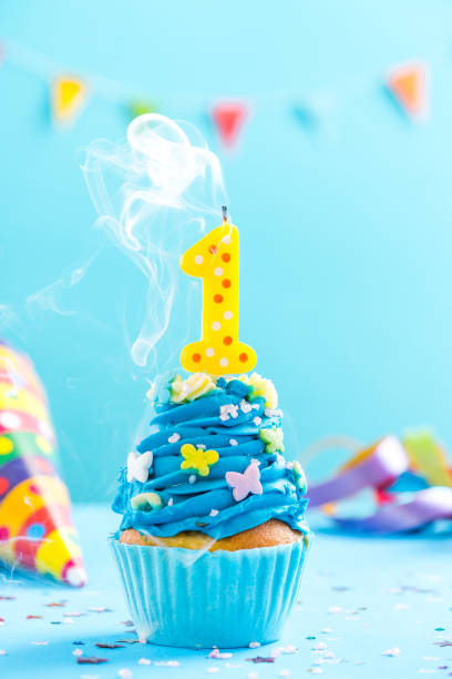 istock First 1st birthday cupcake with candle blow out.Card mockup. 884893660