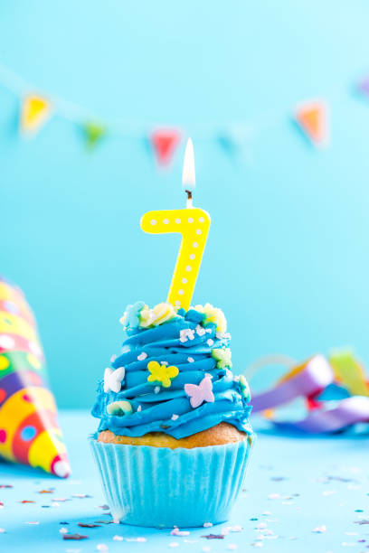 istock Seventh 7th birthday cupcake with candle. Card mockup. 884893918