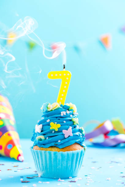 istock Seventh 7th birthday cupcake with candle blow out.Card mockup. 884894420