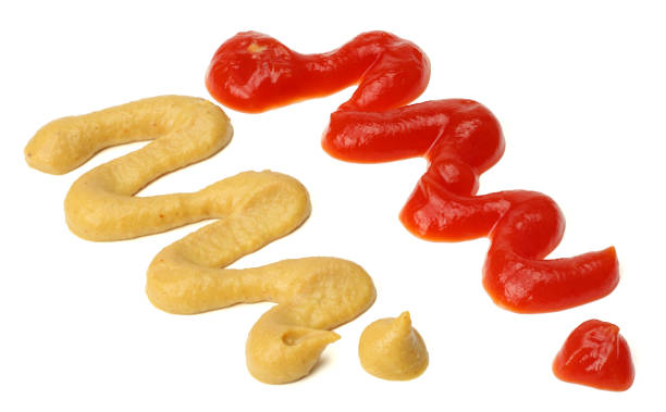 istock Ketchup and mustard wave, splashes. Isolated on white background 884912594