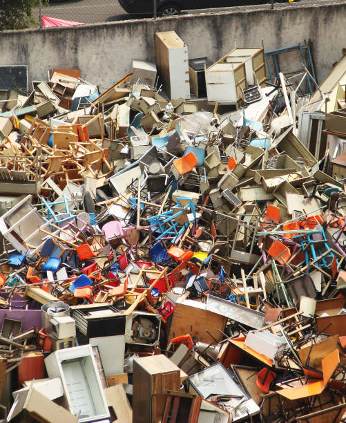 istock Pile of school desks, chairs and debris in a city plot 884922838