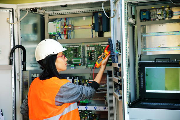 Electrician testing for voltage in a fuse box Young female maintenance engineer testing voltage multimeter stock pictures, royalty-free photos & images