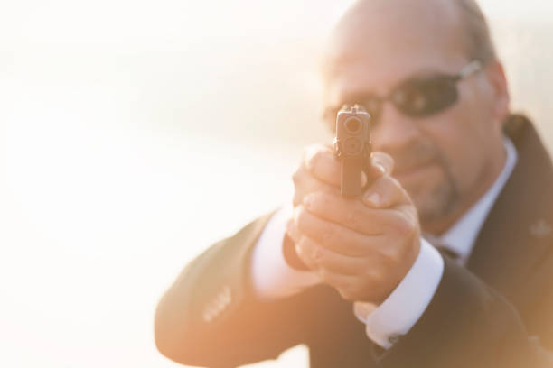 istock Close up Security Businessman with a handgun on bokeh backgorund 884971738