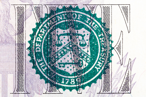 Department of the Treasury a print on five U.S. dollar bill. High resolution photo.