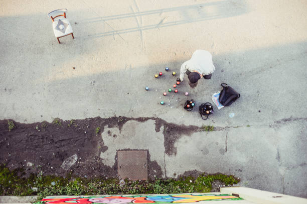istock Graffiti Artist Picking Up Spray Can 884972090