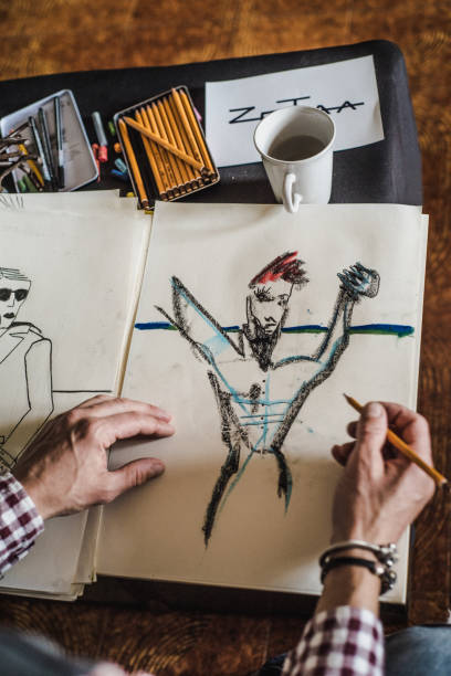 istock Artist In His Studio Creating Drawings 884992722
